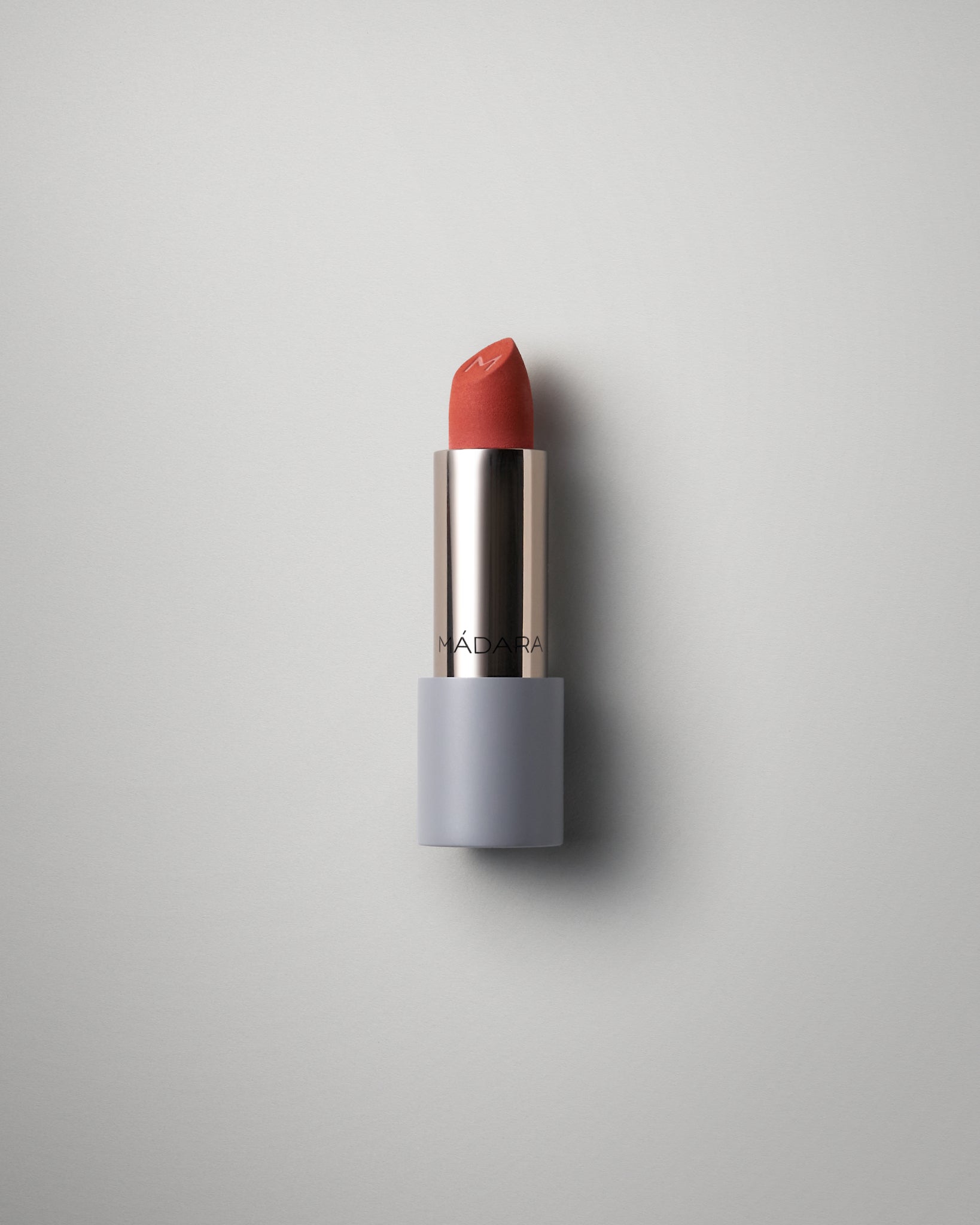 MÁDARA Organic Skincare matte cream lipstick magma A6303 face cream product photo on plain background.