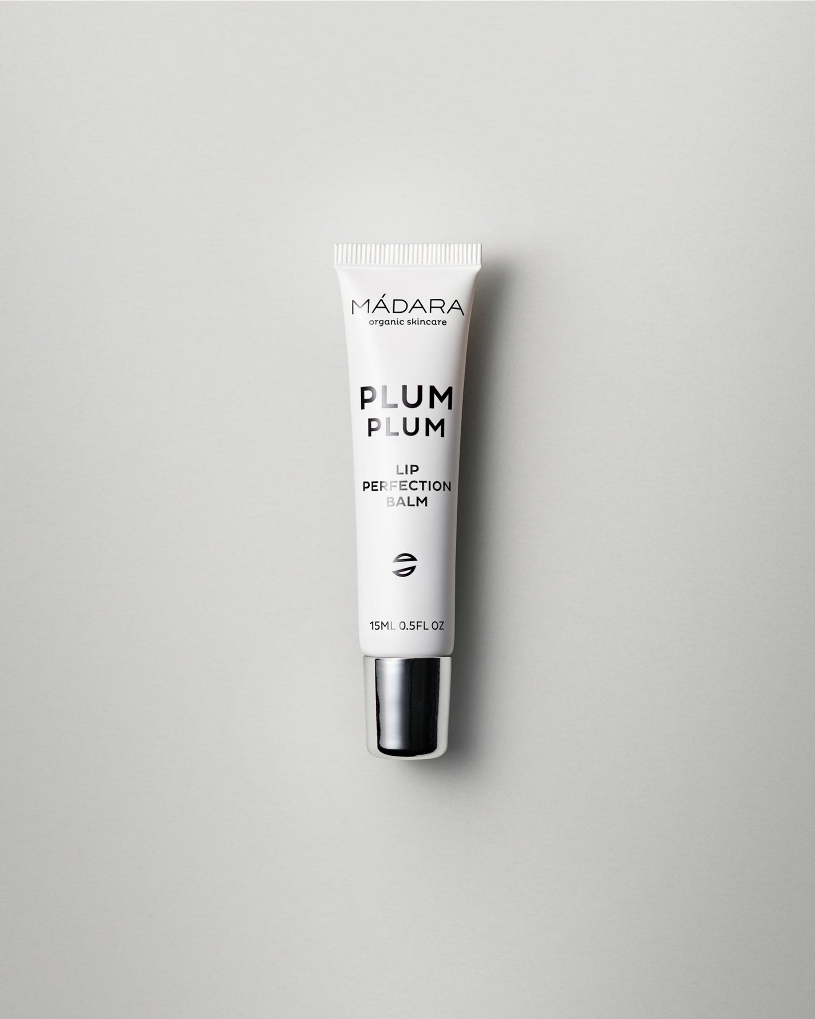 MΓDARA Organic Skincare plum plum lip balm A2291 balm product photo on plain background.