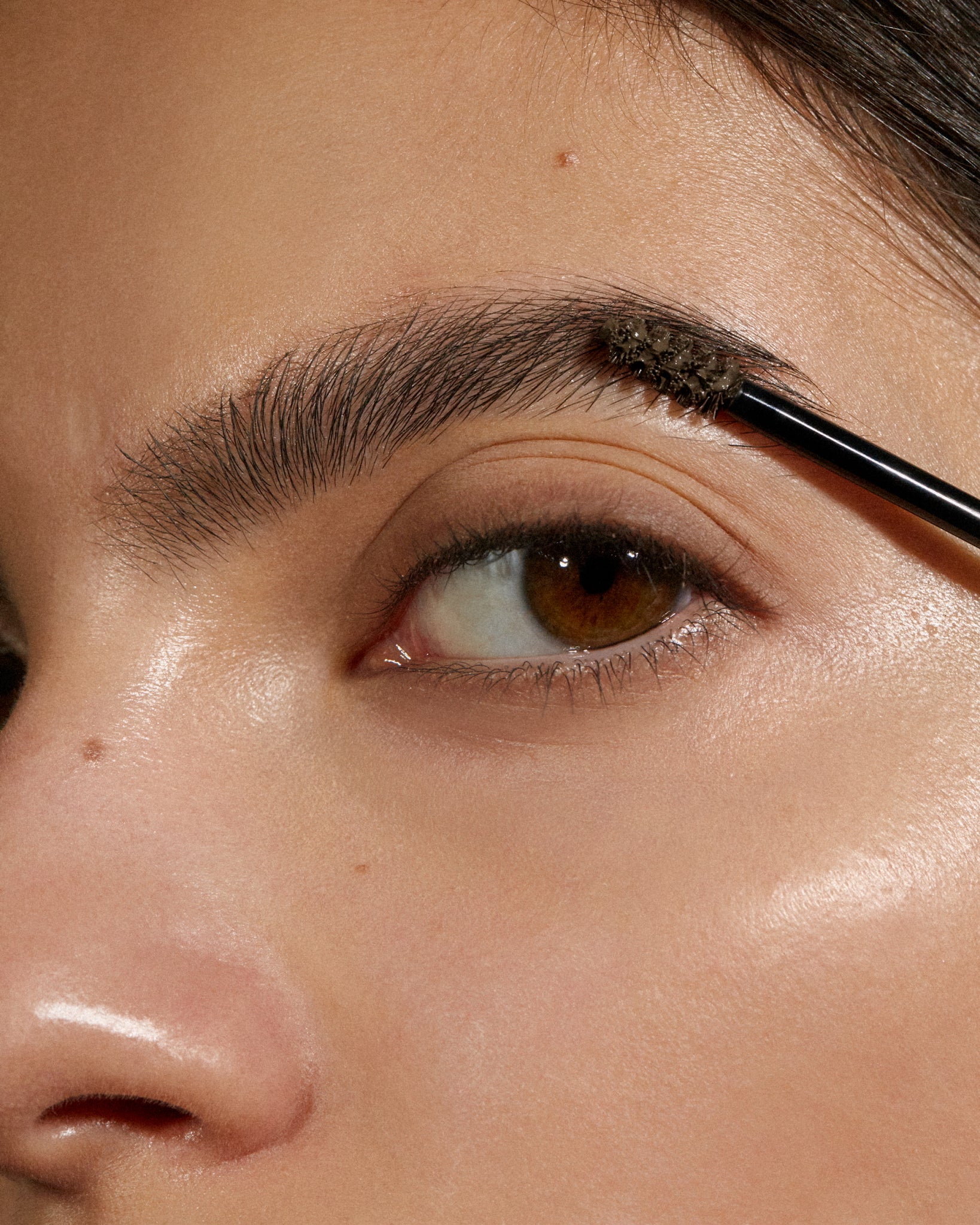 Model wearing MÁDARA Organic Skincare brow and lash booster ash brown on A6704 on skin; close-up portrait shows natural application results.