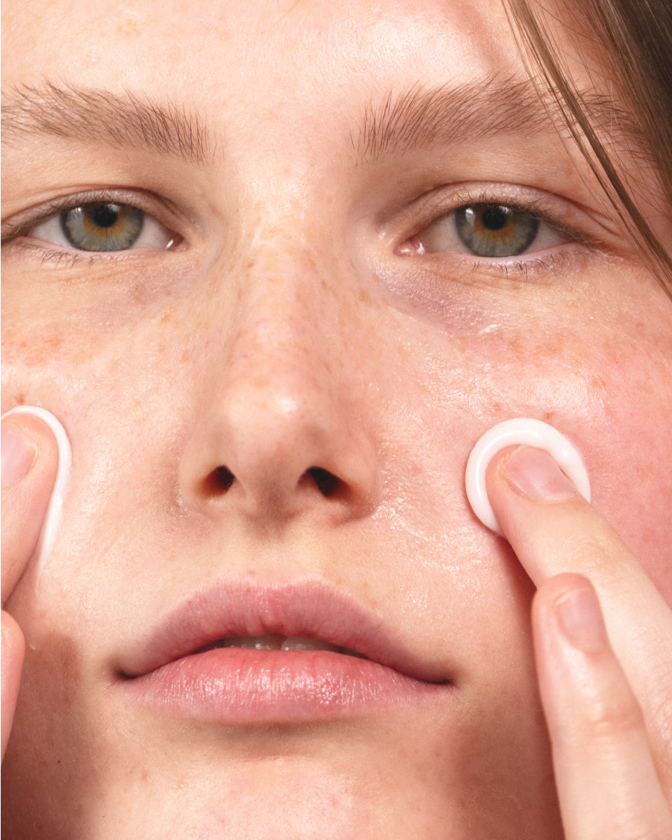 Model applying MΓDARA Derma Collagen Peptide Day Cream to face β deeply hydrating organic moisturizer with peptides for plump, voluminous, and supple skin