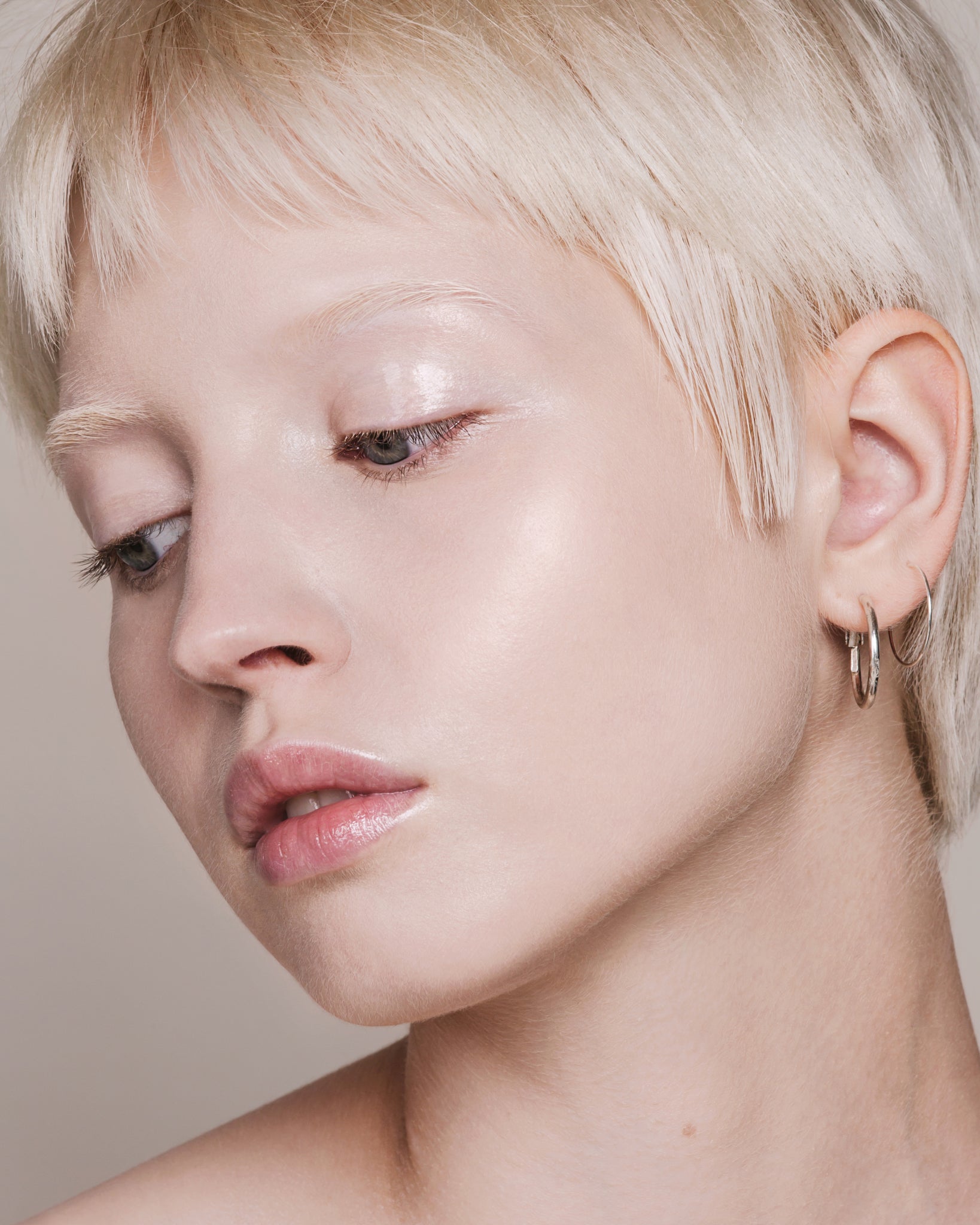 Model wearing MΓDARA Organic Skincare skin equal porcelain on A6051 on skin; close-up portrait shows natural application results.