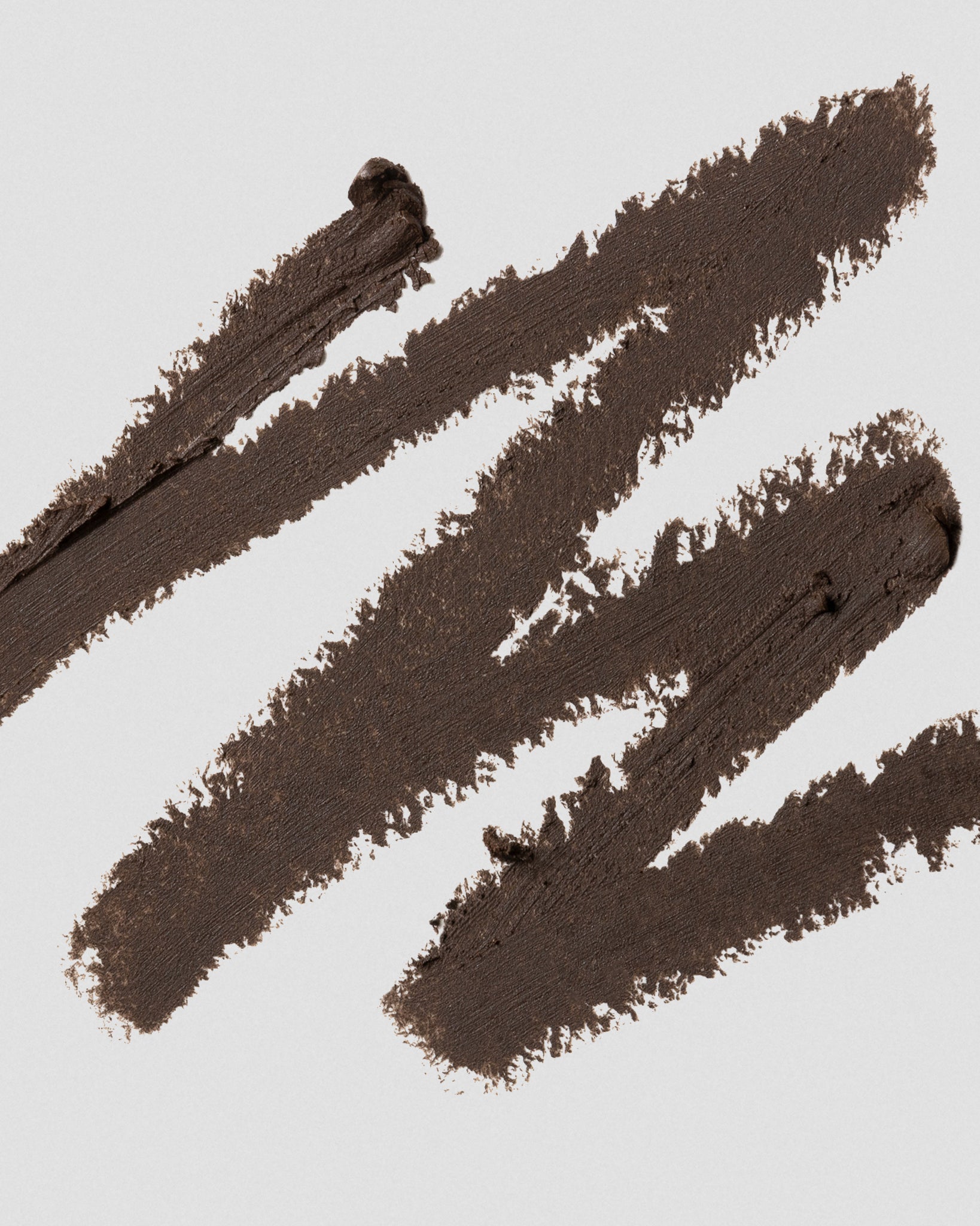 Texture close-up of MÁDARA Organic Skincare eye pencil brown A6882 eye contour care �swatch demonstrates consistency and finish.
